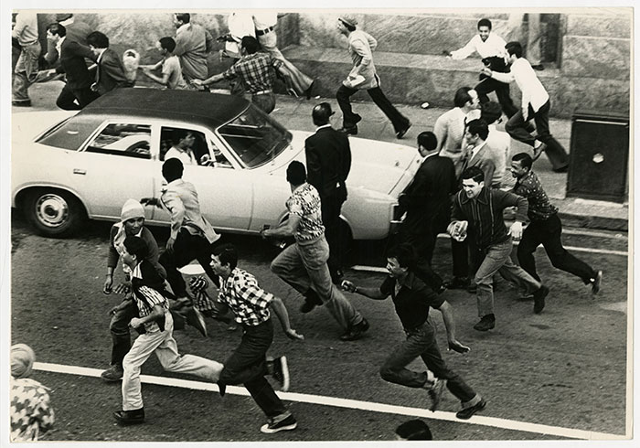 Crowds scatter up Darling Street 