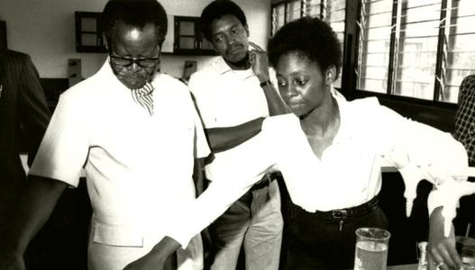 Oliver Tambo with students in a science lesson 